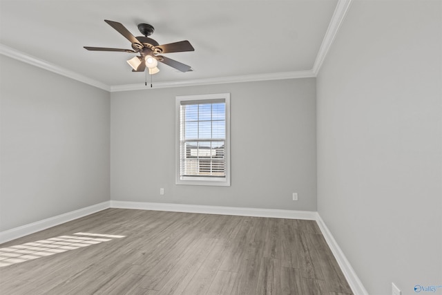 spare room featuring crown molding, ceiling fan, and light wood-type flooring