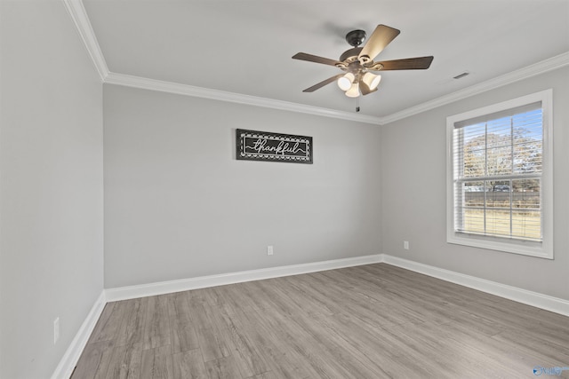 empty room featuring wood-type flooring, ceiling fan, and ornamental molding