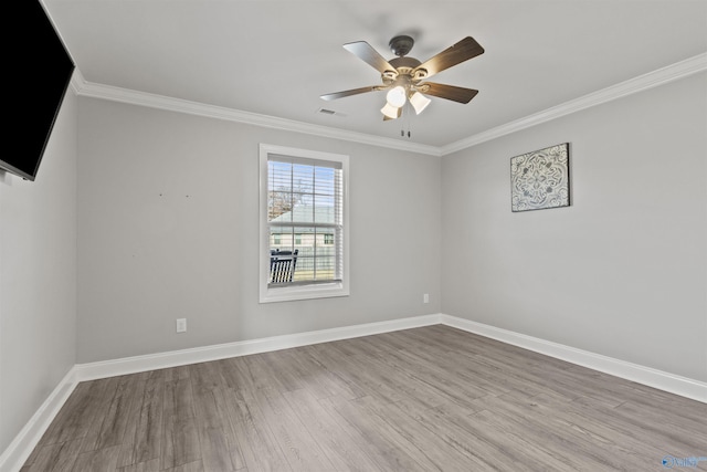 empty room featuring ceiling fan, light hardwood / wood-style floors, and ornamental molding