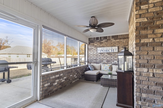 sunroom featuring ceiling fan and a healthy amount of sunlight