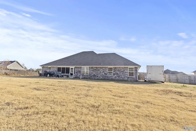 back of property featuring a lawn