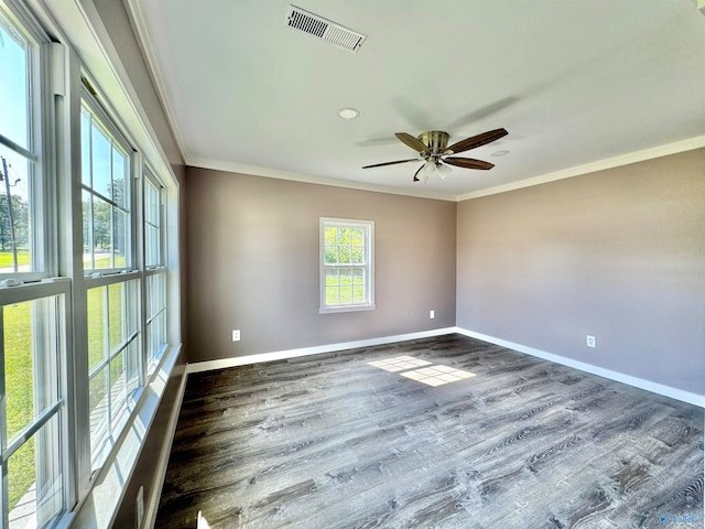 empty room featuring dark wood-type flooring, crown molding, and ceiling fan