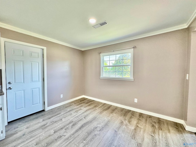 interior space with light hardwood / wood-style floors and ornamental molding