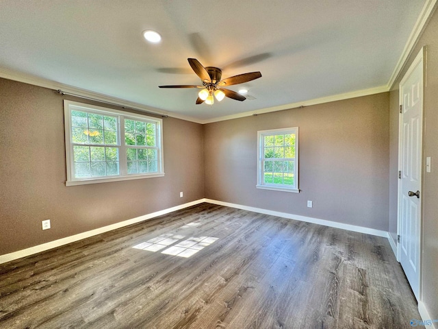 unfurnished bedroom with ornamental molding, multiple windows, ceiling fan, and hardwood / wood-style floors