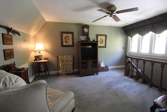 living room featuring ceiling fan, carpet flooring, and vaulted ceiling