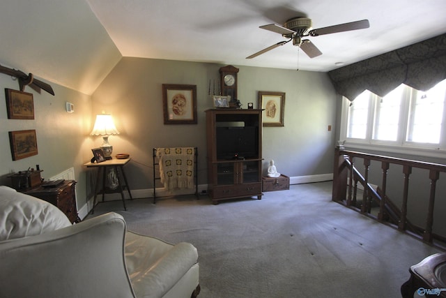 carpeted living room featuring vaulted ceiling, baseboards, and ceiling fan