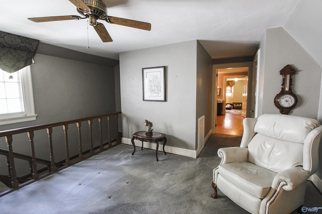 sitting room with carpet, baseboards, and ceiling fan