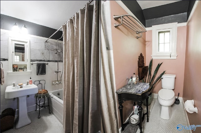 bathroom featuring toilet, shower / bathtub combination with curtain, and tile patterned flooring