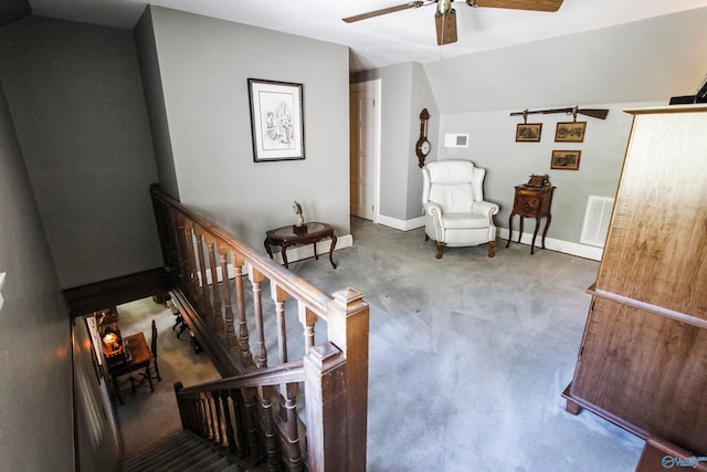 interior space featuring ceiling fan, carpet, and lofted ceiling