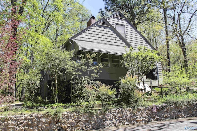 view of property exterior featuring a chimney