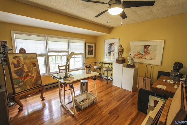 office with a ceiling fan, wood finished floors, and a textured ceiling