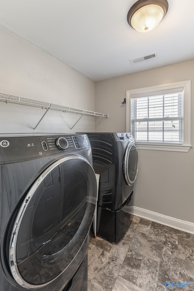 washroom featuring washer and clothes dryer