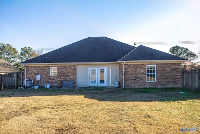 rear view of property featuring a lawn