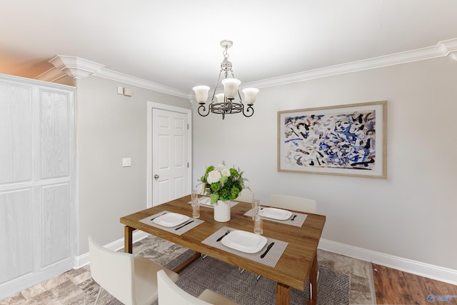 dining space featuring an inviting chandelier, crown molding, and baseboards