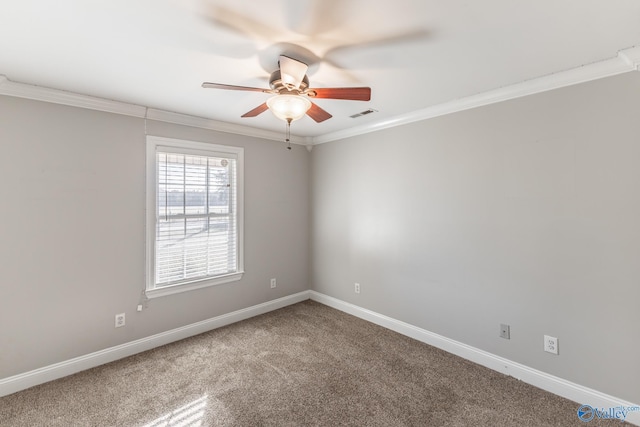 carpeted spare room with ceiling fan and crown molding