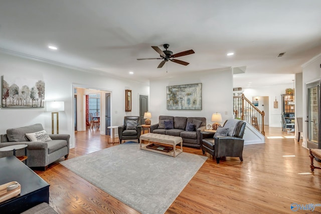 living room featuring recessed lighting, visible vents, stairs, and light wood finished floors