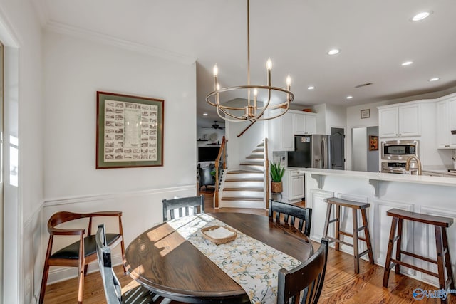 dining room with recessed lighting, light wood-style flooring, stairs, and ornamental molding