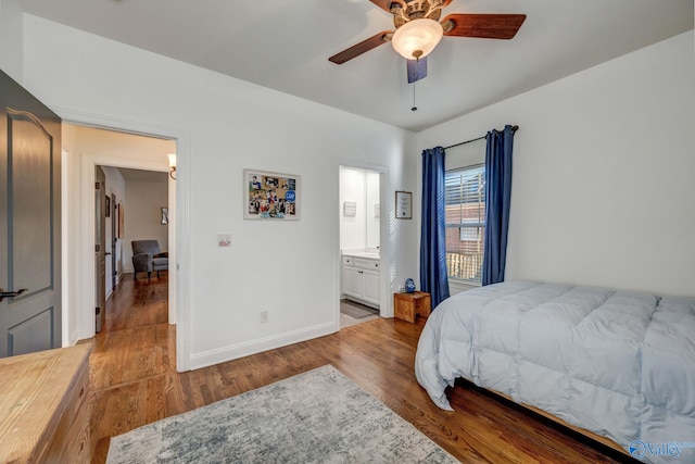 bedroom with ceiling fan, ensuite bathroom, baseboards, and wood finished floors