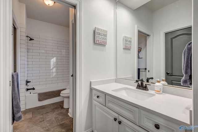 bathroom with washtub / shower combination, toilet, and vanity