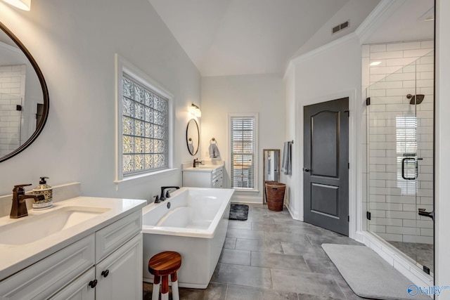 full bathroom with a shower stall, vaulted ceiling, visible vents, and a sink