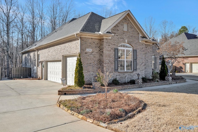 view of front of home featuring brick siding, fence, concrete driveway, roof with shingles, and a garage