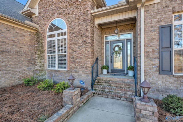 property entrance with brick siding and roof with shingles