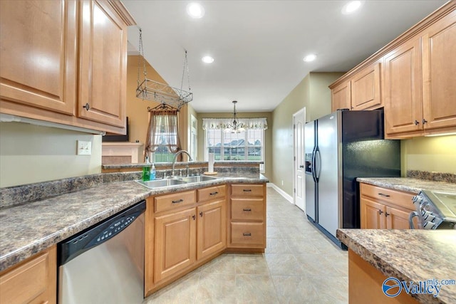 kitchen featuring light tile patterned flooring, stainless steel appliances, pendant lighting, sink, and a chandelier