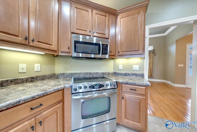 kitchen with appliances with stainless steel finishes and light hardwood / wood-style flooring