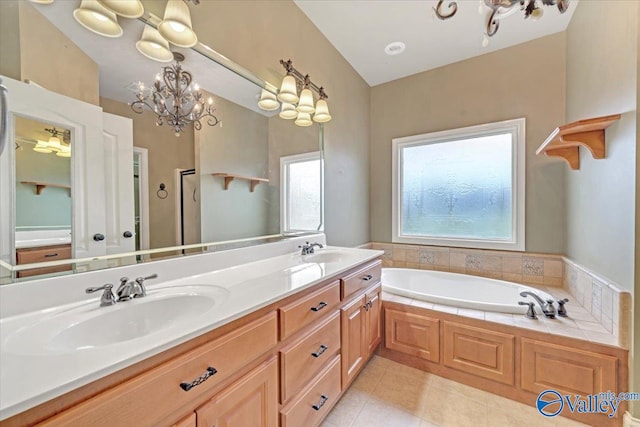 bathroom with vanity, a tub, tile patterned floors, and a notable chandelier