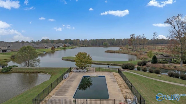 view of pool featuring a water view and a yard