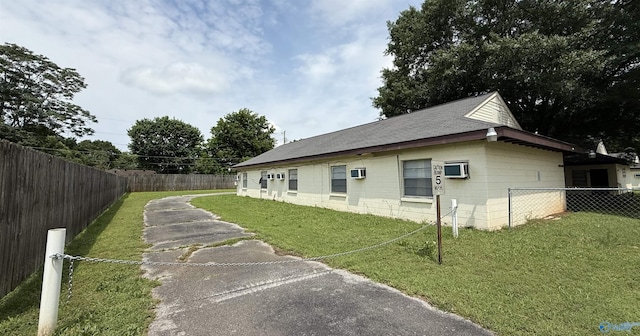 3004 SW Clopton St Unit 28, Huntsville, AL 35805 - view of property exterior with driveway, a shingled roof, and concrete block siding