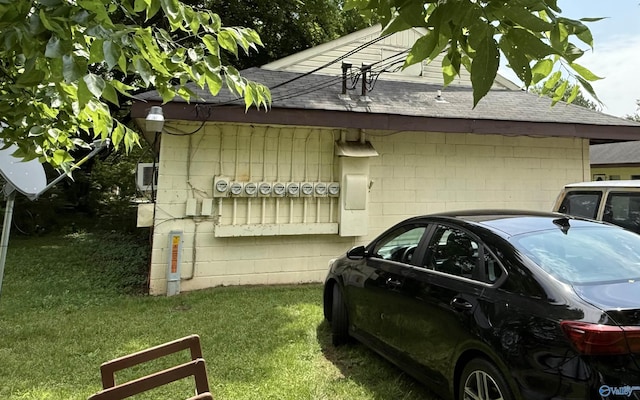 3004 SW Clopton St Unit 28, Huntsville, AL 35805 - view of side of property with a shingled roof, a lawn, and concrete block siding