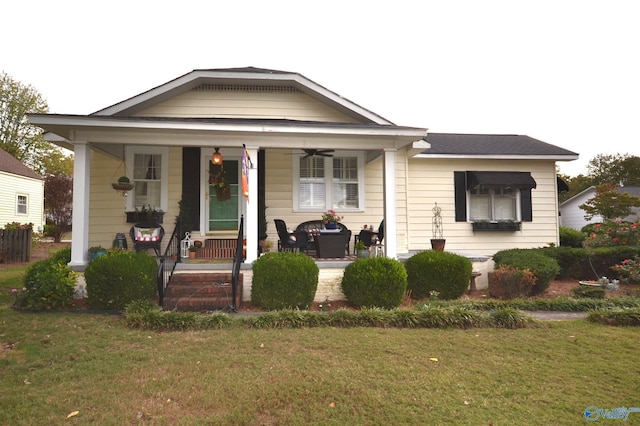 bungalow-style house featuring covered porch and a front lawn