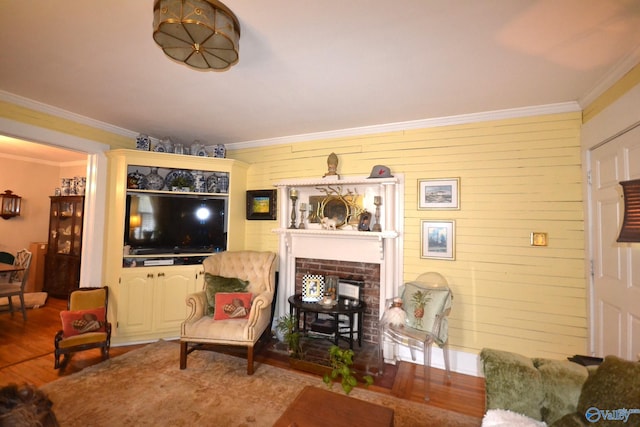 living room featuring ornamental molding, a fireplace, and wood-type flooring