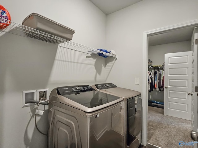 laundry area with laundry area, carpet, and washer and clothes dryer