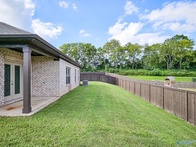 view of yard featuring a fenced backyard, a patio, cooling unit, and french doors