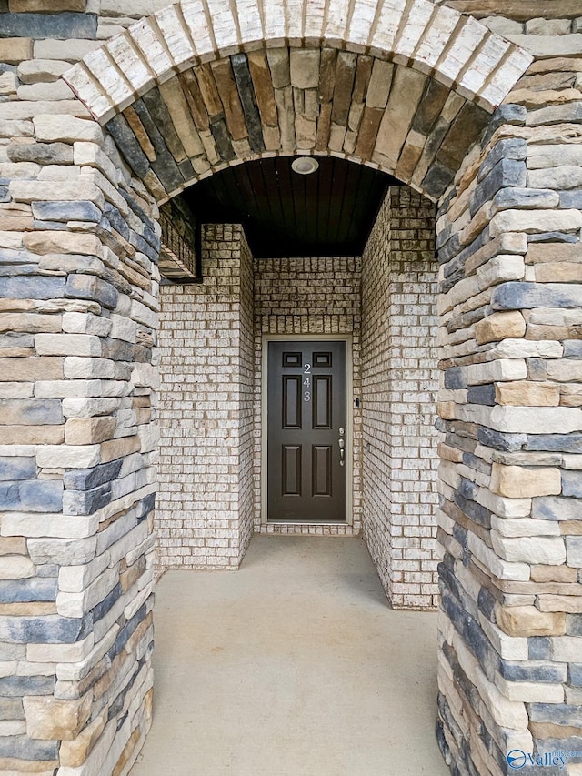 property entrance featuring brick siding