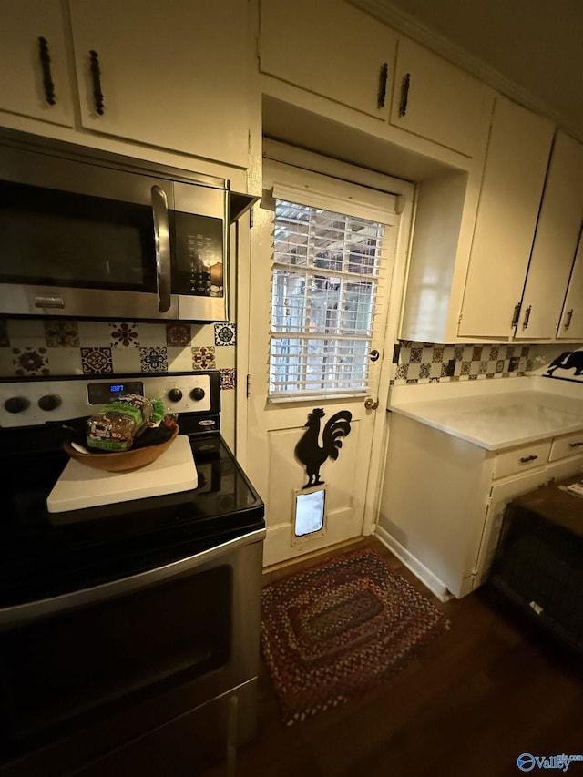 interior space featuring decorative backsplash, stainless steel appliances, light countertops, and wood finished floors