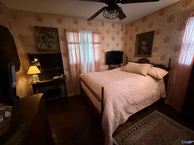 bedroom with a ceiling fan and wallpapered walls