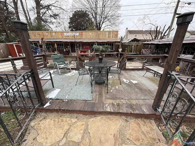 view of patio featuring outdoor dining area and a wooden deck