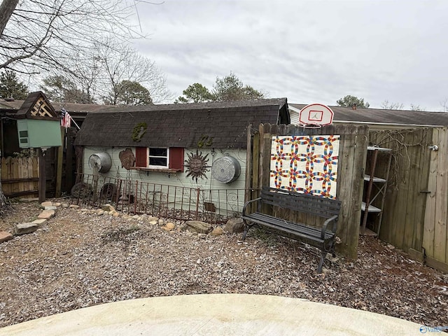 view of front of house with roof with shingles and fence