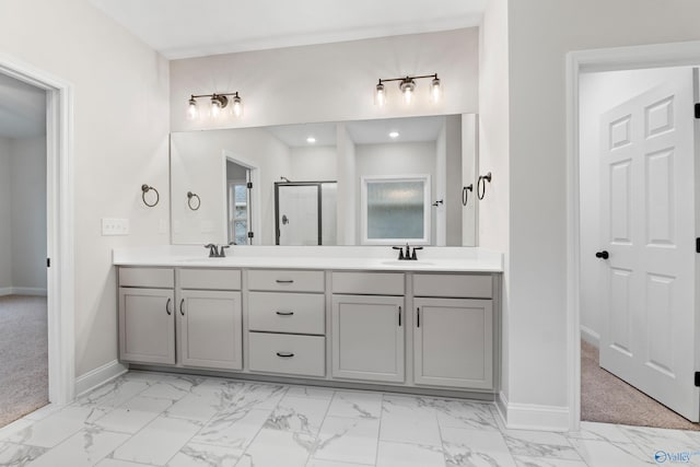 full bathroom featuring double vanity, marble finish floor, and a sink