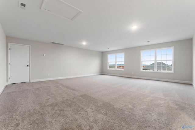 spare room with recessed lighting, baseboards, visible vents, and carpet floors