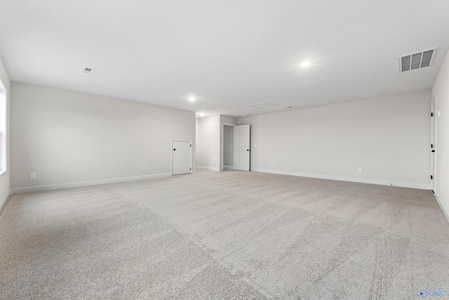 spare room featuring recessed lighting, visible vents, baseboards, and carpet