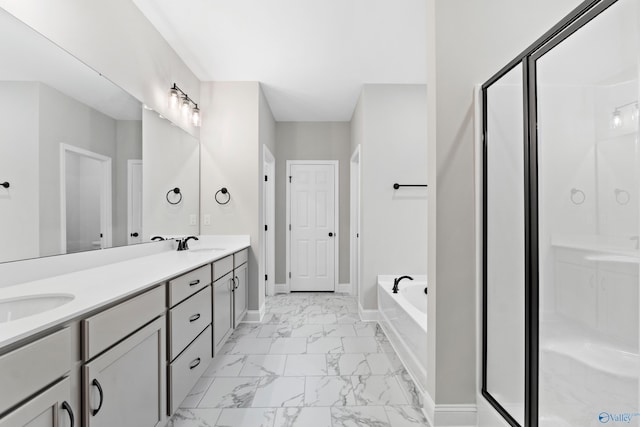 full bath featuring a bath, marble finish floor, a shower stall, and a sink