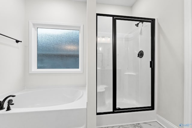 full bathroom with marble finish floor, a stall shower, baseboards, and a garden tub