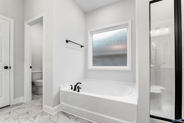 full bath featuring baseboards, a stall shower, a garden tub, toilet, and marble finish floor