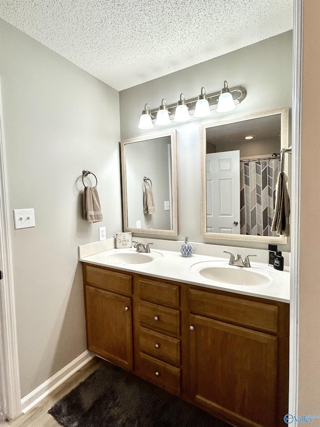 bathroom featuring vanity and a textured ceiling