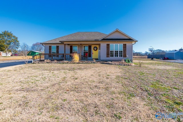 ranch-style house with a porch and a front yard