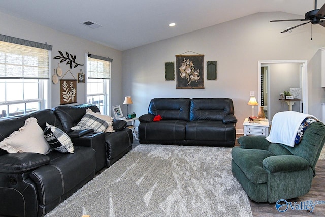 living room featuring ceiling fan, vaulted ceiling, and hardwood / wood-style floors